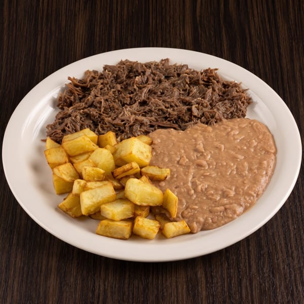 Plate of shredded meat, refried beans, and golden fried plantain pieces on a white plate.
