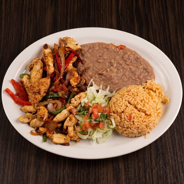 Plate of grilled chicken fajitas with peppers, onions, refried beans, Mexican rice, and a fresh lettuce-pico de gallo salad.
