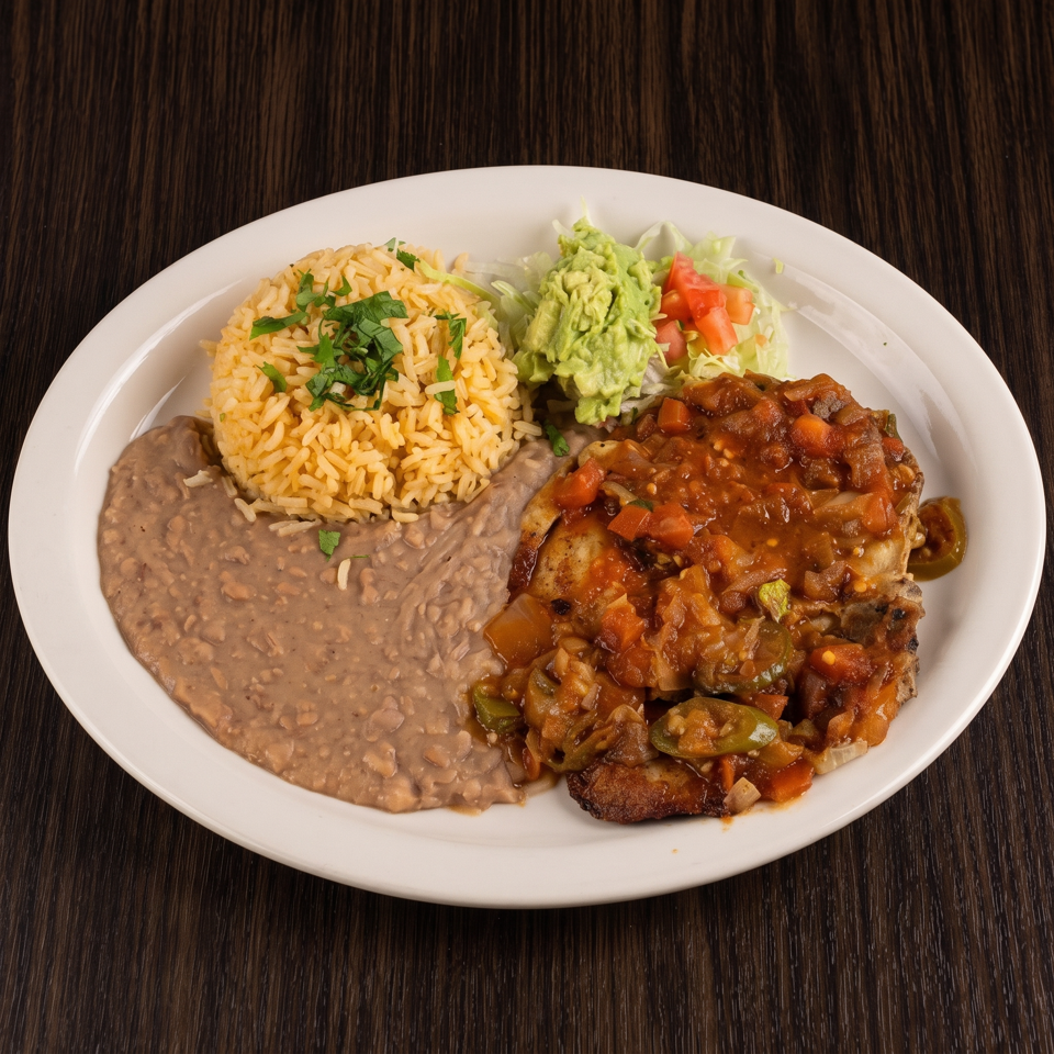 Mexican-style platter with grilled chicken in tomato salsa, cilantro rice, refried beans, guacamole, and salad.